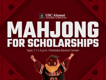 A promotional graphic for a Mahjong fundraising event titled 'MAHJONG FOR SCHOLARSHIPS,' featuring a cartoonish mascot in a red and black outfit holding up its hands. The event is scheduled for September 7 from 1 to 5 p.m. at the Pastides Alumni Center, with organizational branding for USC Alumni and Columbia Gamecocks in the background.