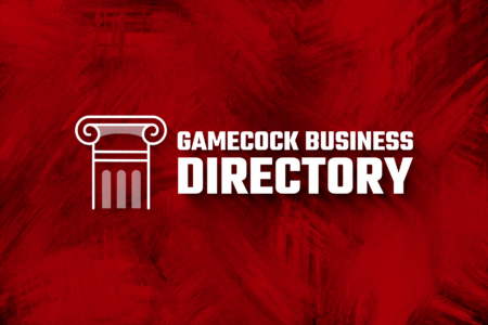 A graphic featuring the text 'GAMECOCK BUSINESS DIRECTORY' in bold white letters on a textured red background, accompanied by a white outline of a classical column.
