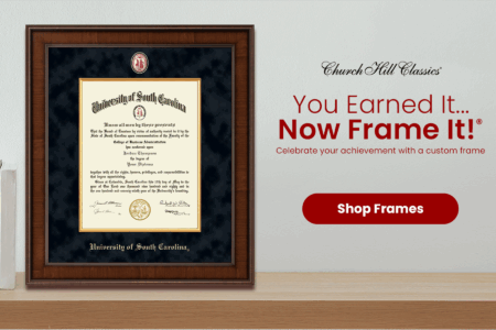 A framed diploma from the University of South Carolina, featuring the text 'University of South Carolina' at the top and the name 'Jordan Thompson' with the degree awarded in the center, surrounded by a wooden frame and dark background. To the right, promotional text encourages customers to celebrate their achievements with custom frames, alongside a red button labeled 'Shop Frames'.