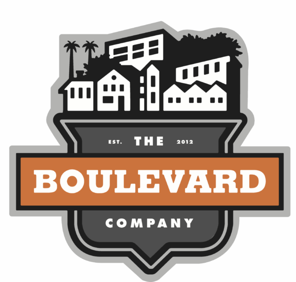 A logo featuring stylized silhouettes of buildings and palm trees, with the words 'THE BOULEVARD COMPANY' prominently displayed in orange and white text on a black background, including 'EST. 2012'.